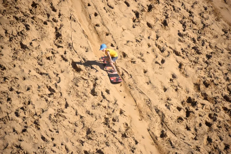 little boy successfully masters the sand dunes