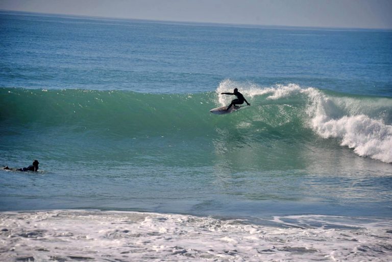 Surfer ride a waves at Achor Point