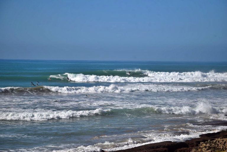 Surfers ride their waves at Achor Point