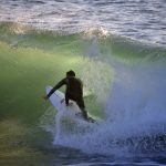Surfers in a tube at Camel Beach, Morocco