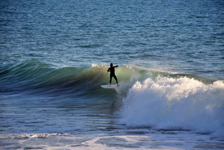 Surfer enjoys a perfect ride in the green waves of Boilers