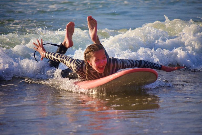 Girl floats lying on the surfboard and has fun
