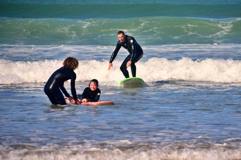 Family surfing course on the beach in Agadir