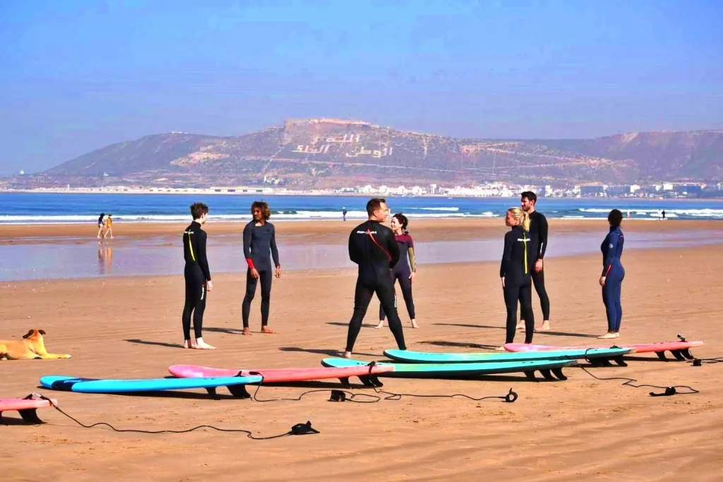 Surf students warm up for the surf course on Agadir beach