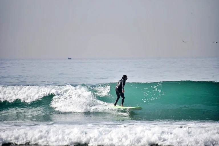 Surfer rides a great green wave at Camel Beach in Morocco