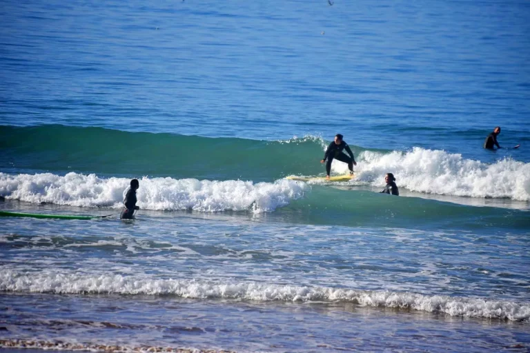 Surf beginners gain their first experiences in the green waves on Agadir beach