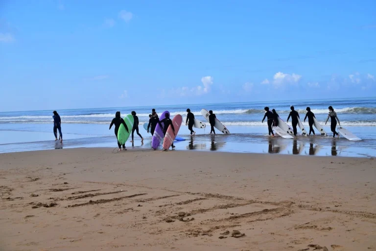 Participants of the group surfing course on their way into the water