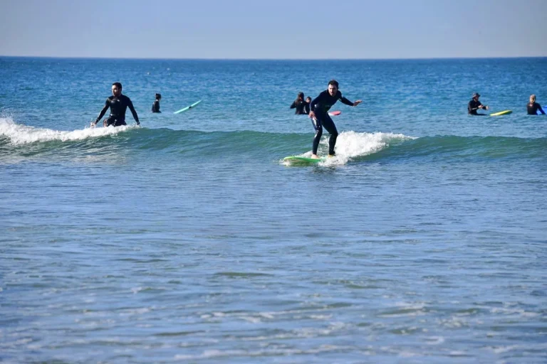 Beginner surfers can enjoy small green waves on the beach of Agadir