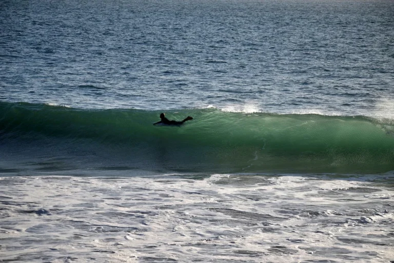 Surfer floating in the middle of a big wave