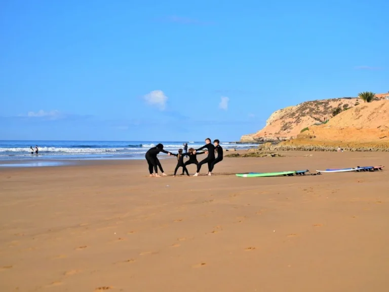 Surfers stretch together before heading into the water