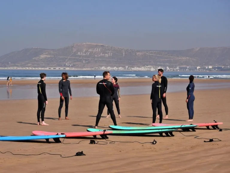 Warm-up for the group surfing course on Agadir beach with a view of the Oufella