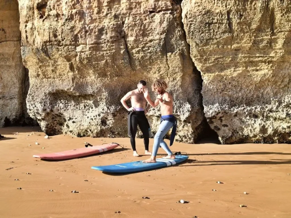 Surf instructor explains turning in the waves on the beach