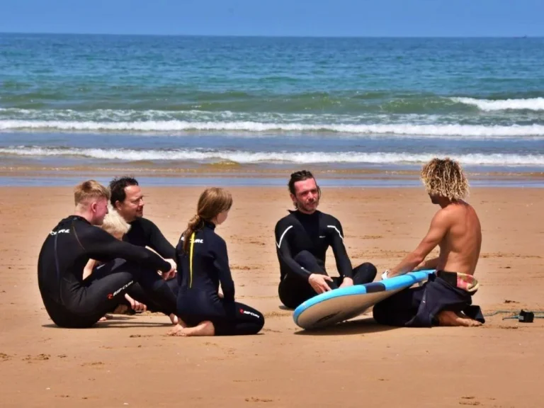 Theoretical briefing in group surfing course on Agadir beach