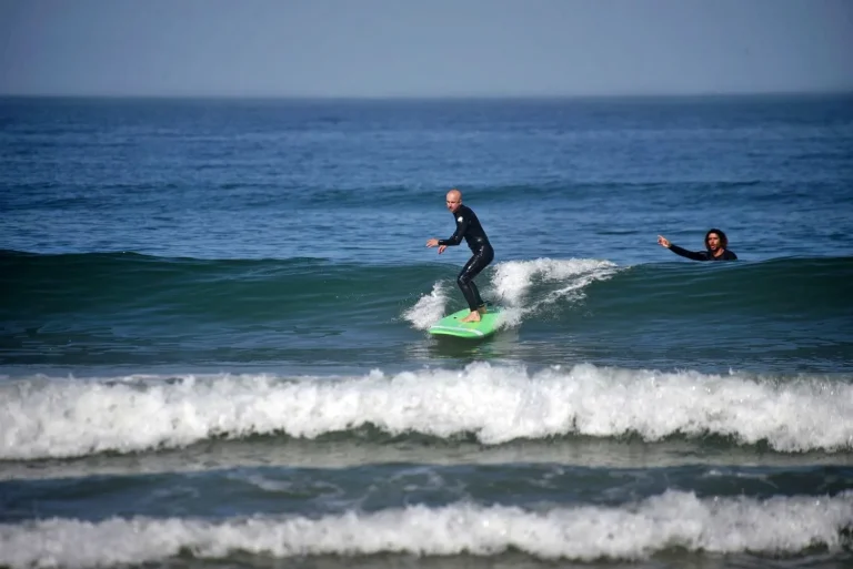Surfing beginner gains his first experiences in the green waves